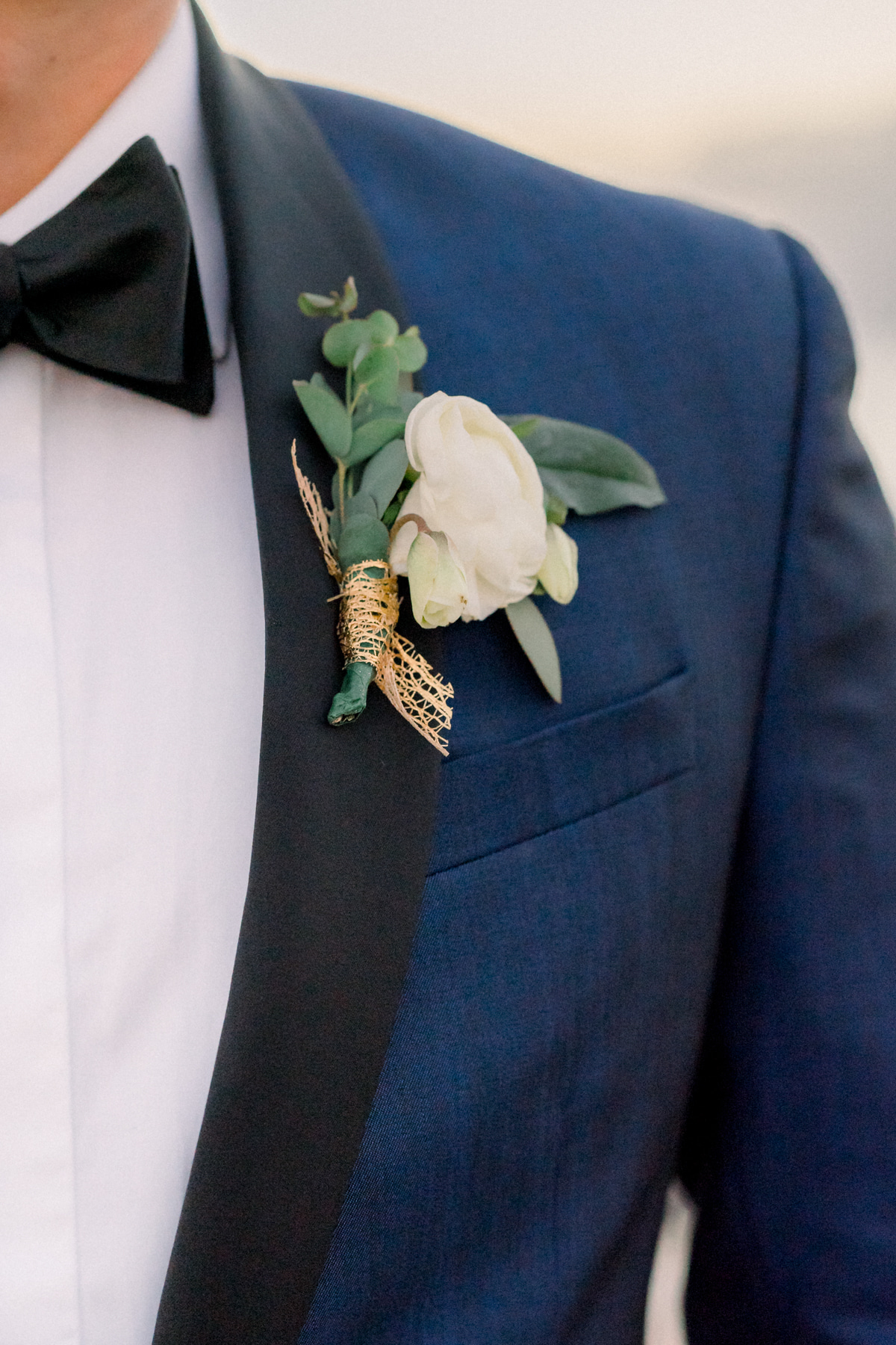 navy blue suit with white flower