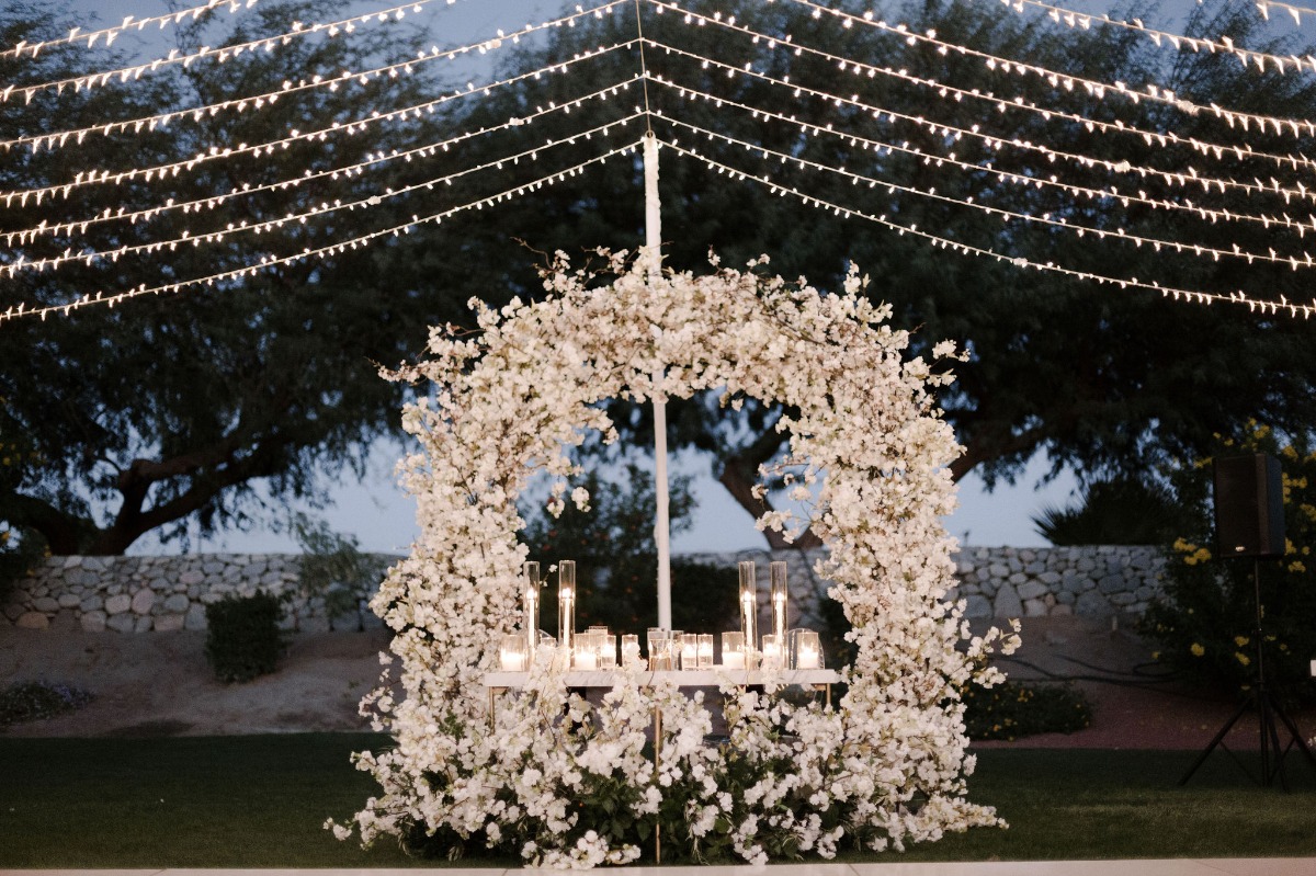 sweetheart table with floral backdrop