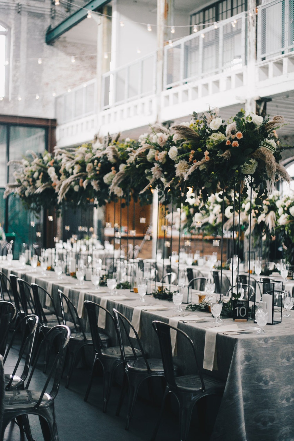 tall wedding centerpieces at industrial venue