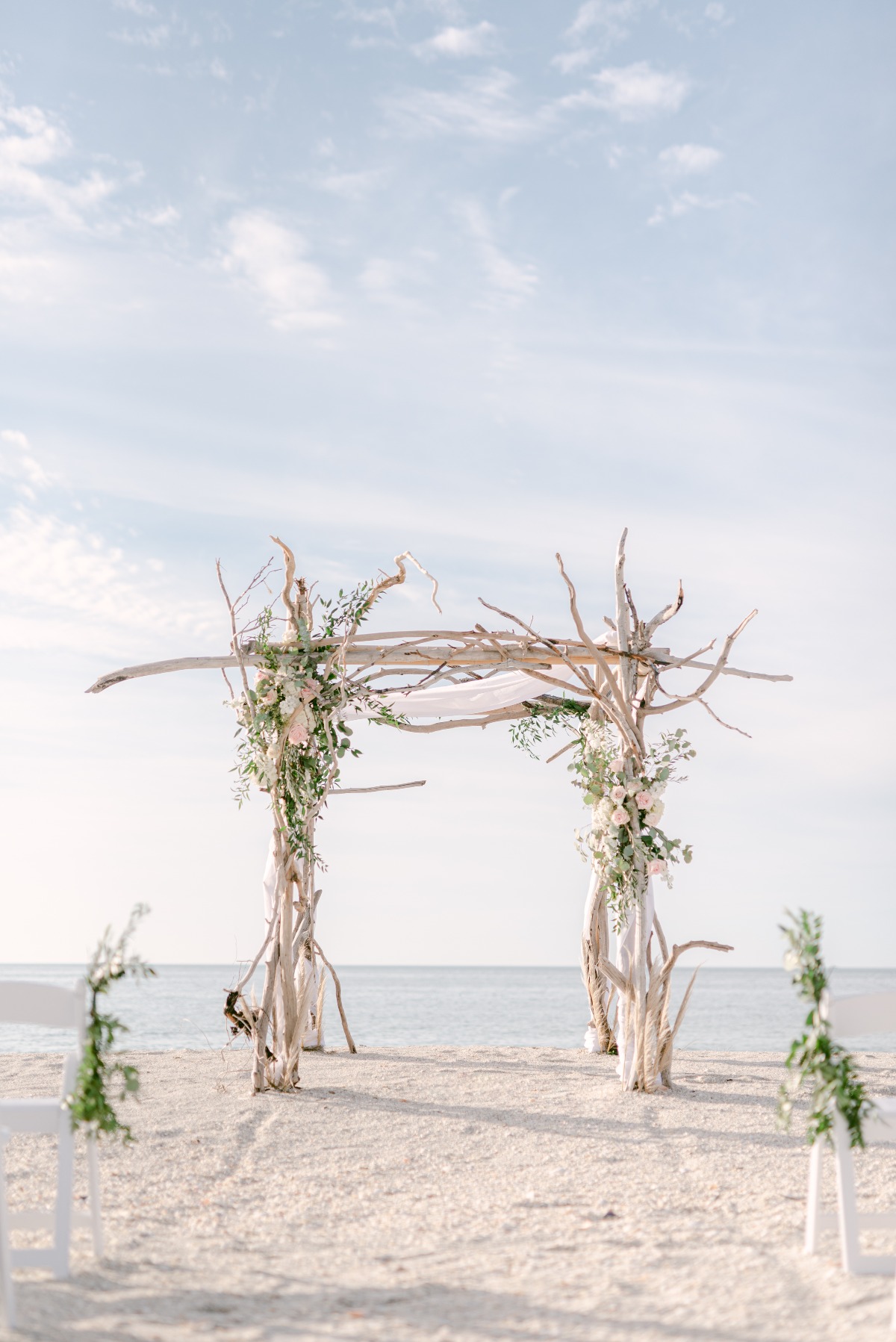 wedding ceremony made of birch wood adorned with flowers