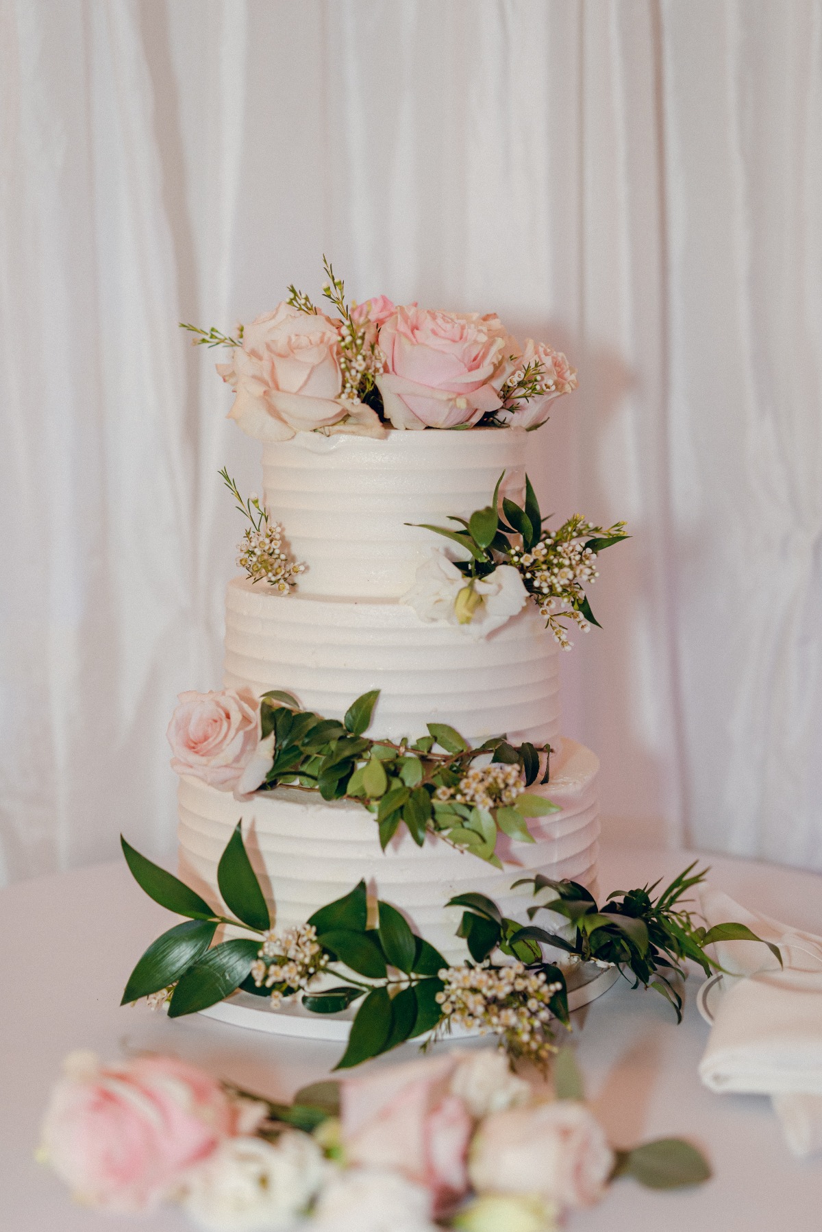 white wedding cake with pink roses