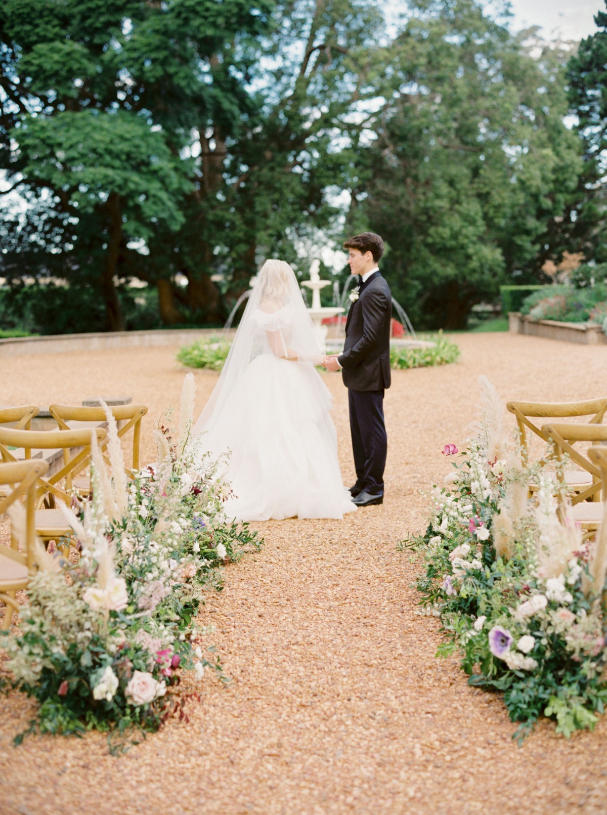 outdoor wedding ceremony with floral aisle decor