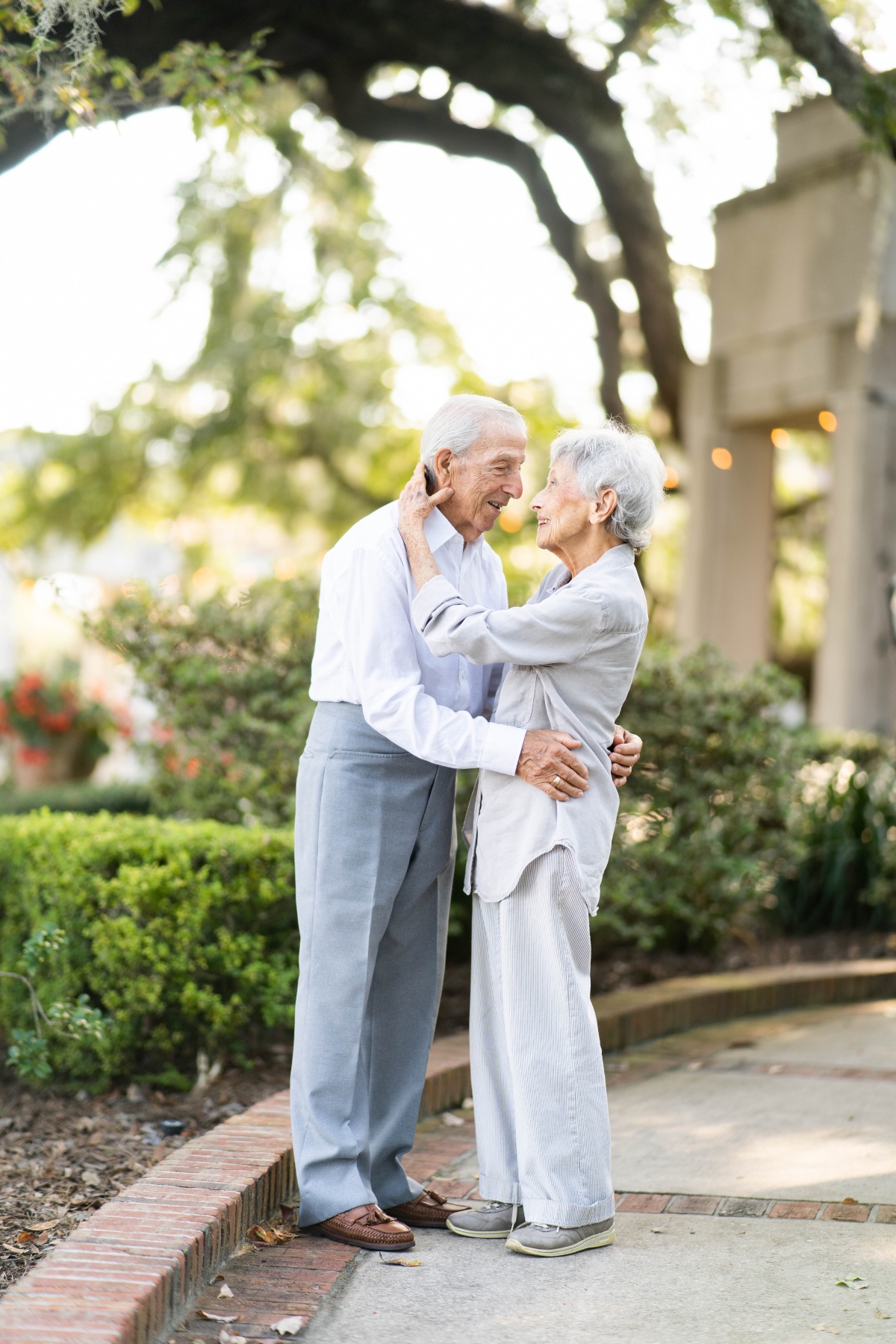 Elderly couple embracing outdoors, showing love and affection