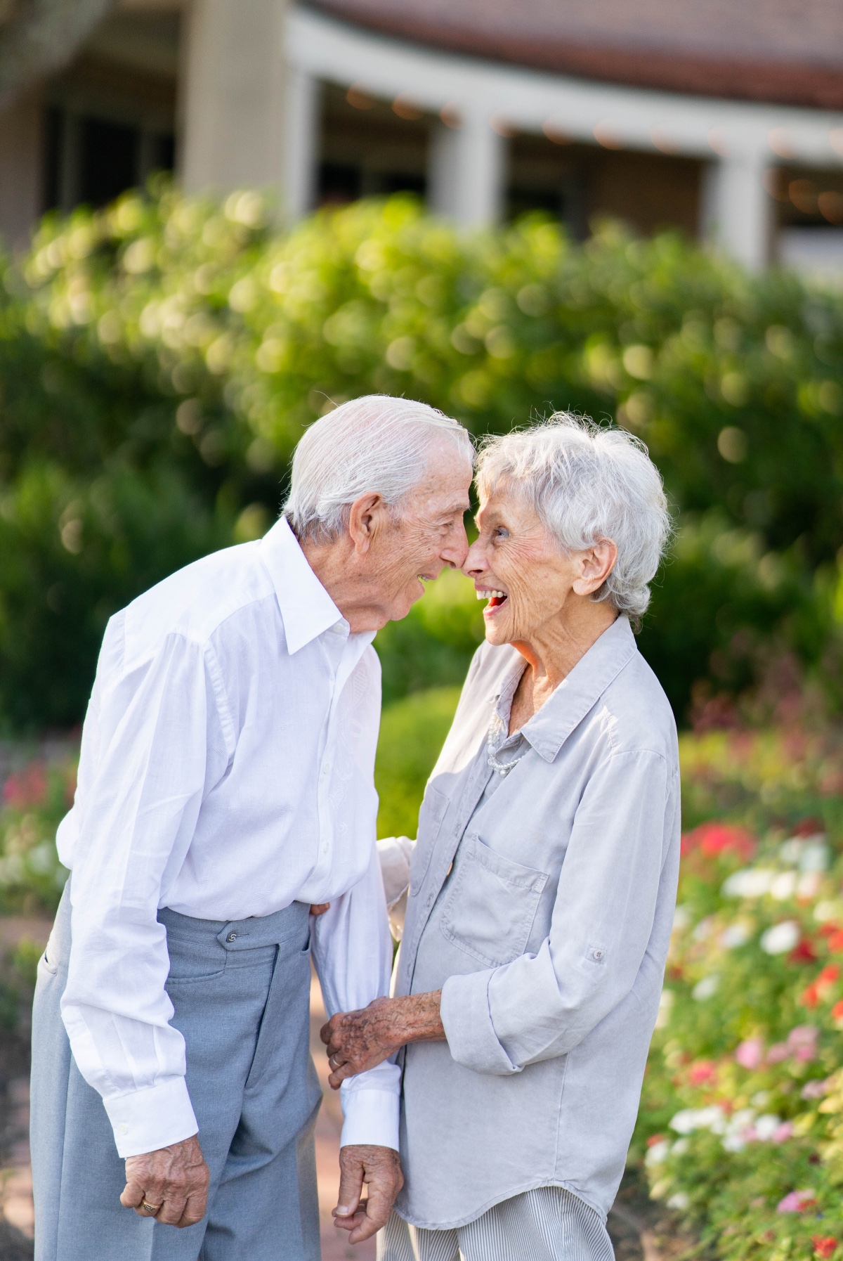Happy senior couple nose to nose in a garden