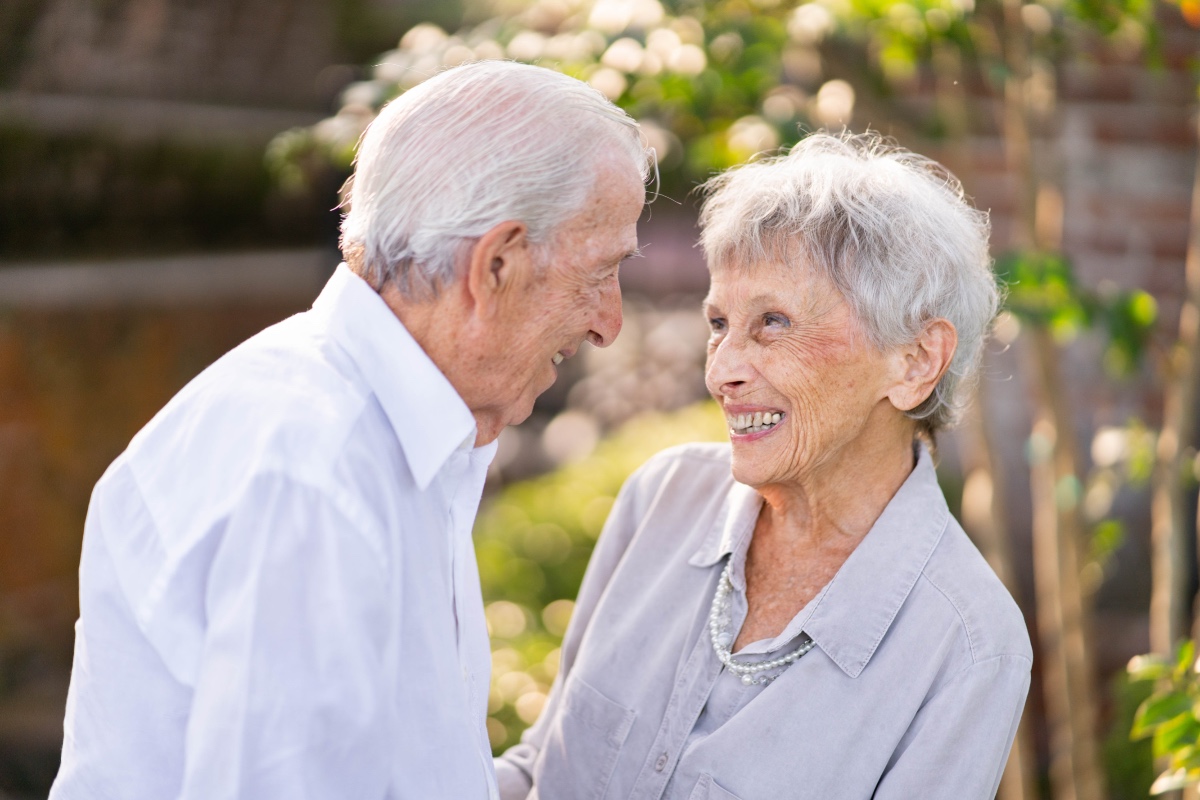 Happy elderly couple looking at each other smiling