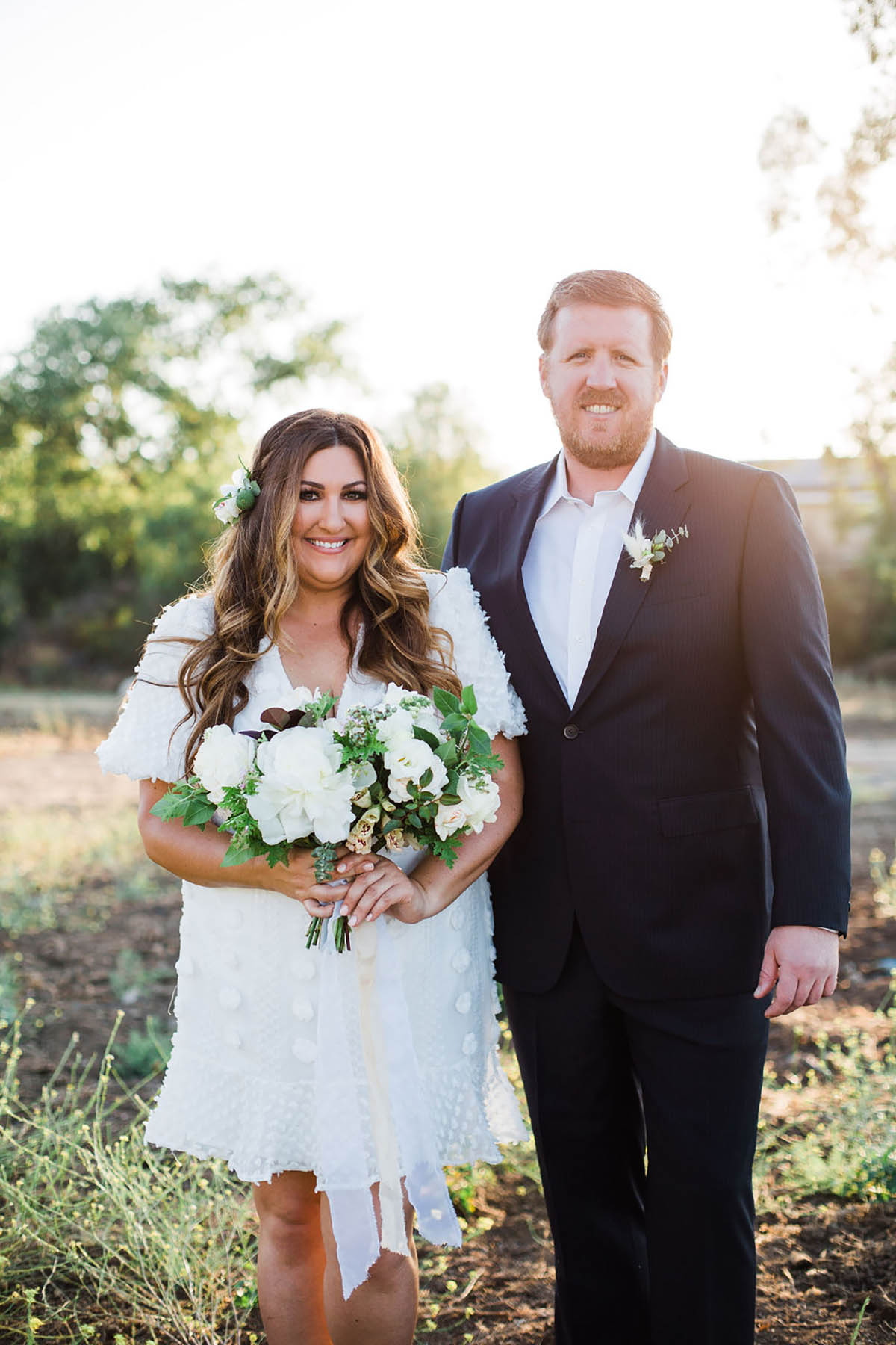 Bride and groom on their wedding day smiling outdoors