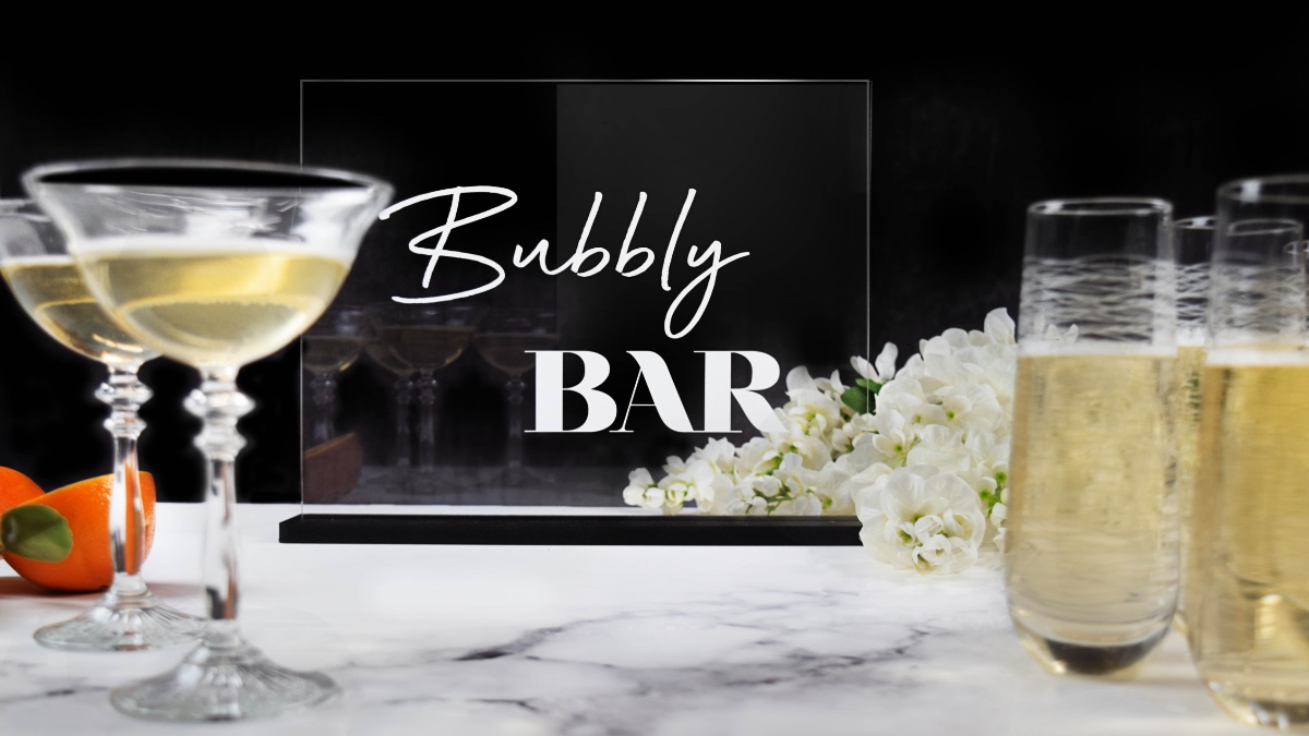 Bubbly Bar sign with champagne glasses and flowers