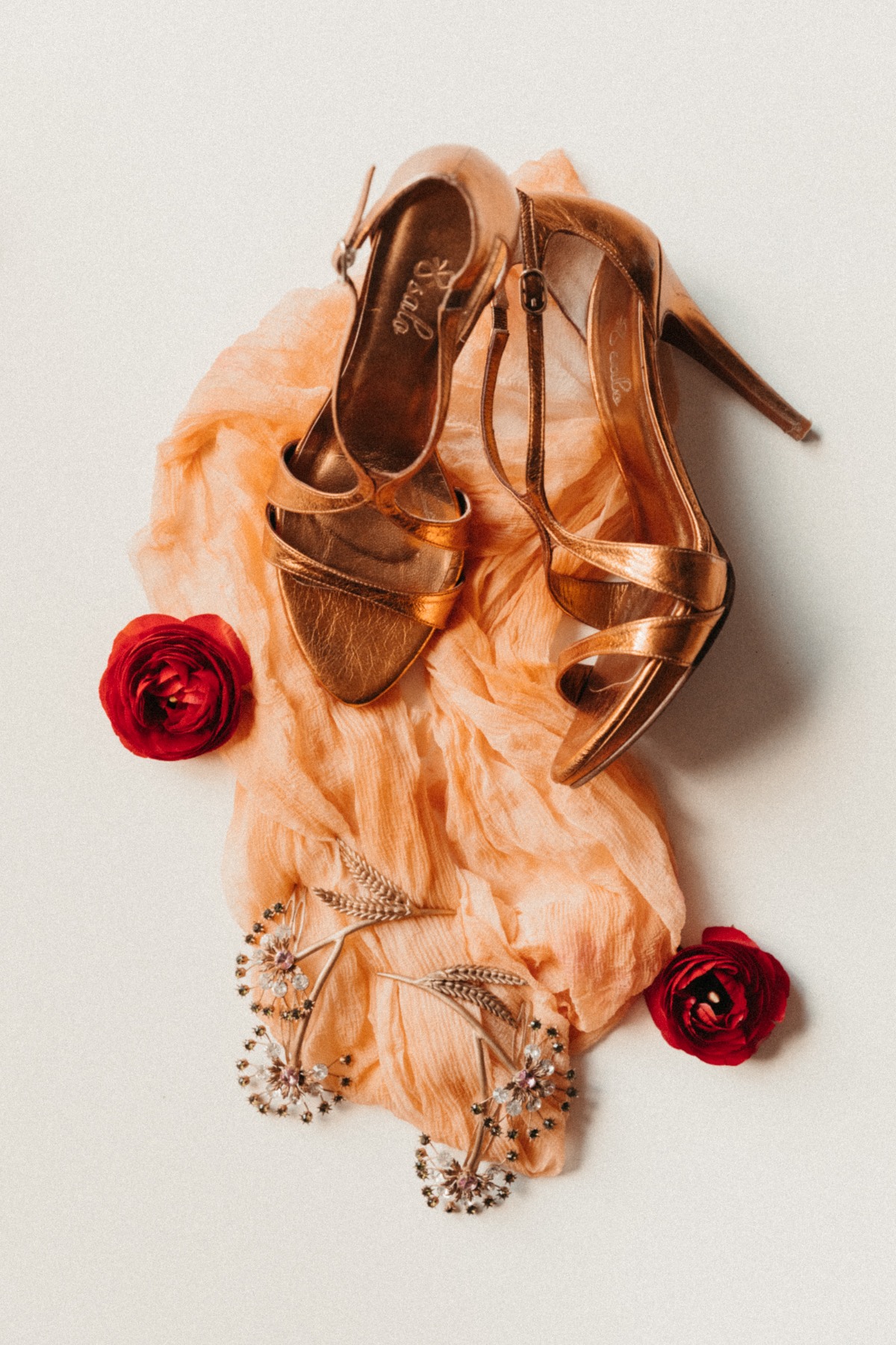 Elegant rose gold heels and bridal accessories layout