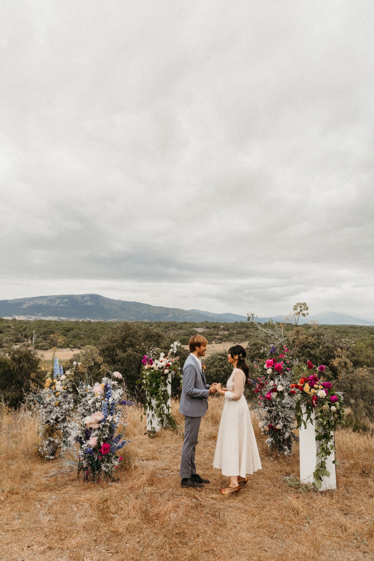 Outdoor wedding ceremony with flowers and mountains