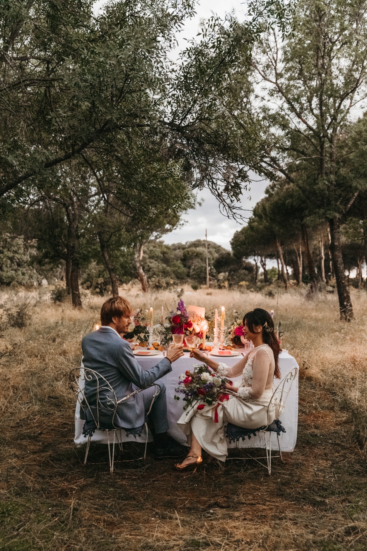 Outdoor forest wedding toast between bride and groom