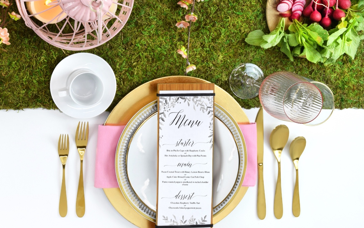 Elegant spring wedding menu on a moss table runner