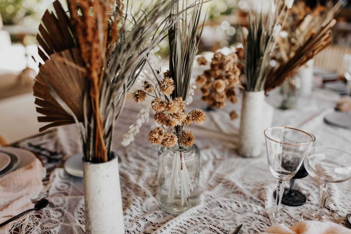 Dried floral centerpieces adorn rustic wedding table