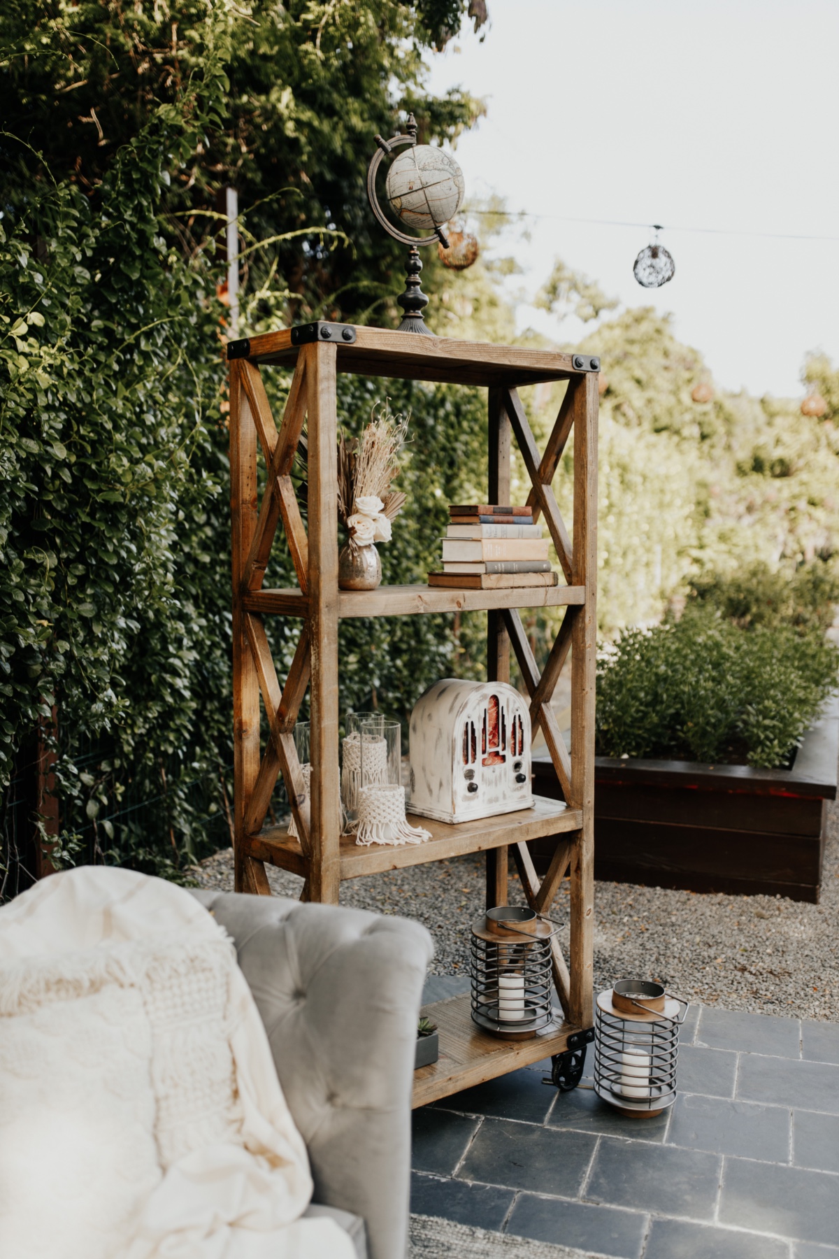 Rustic wooden shelf with globe, books, and vintage radio