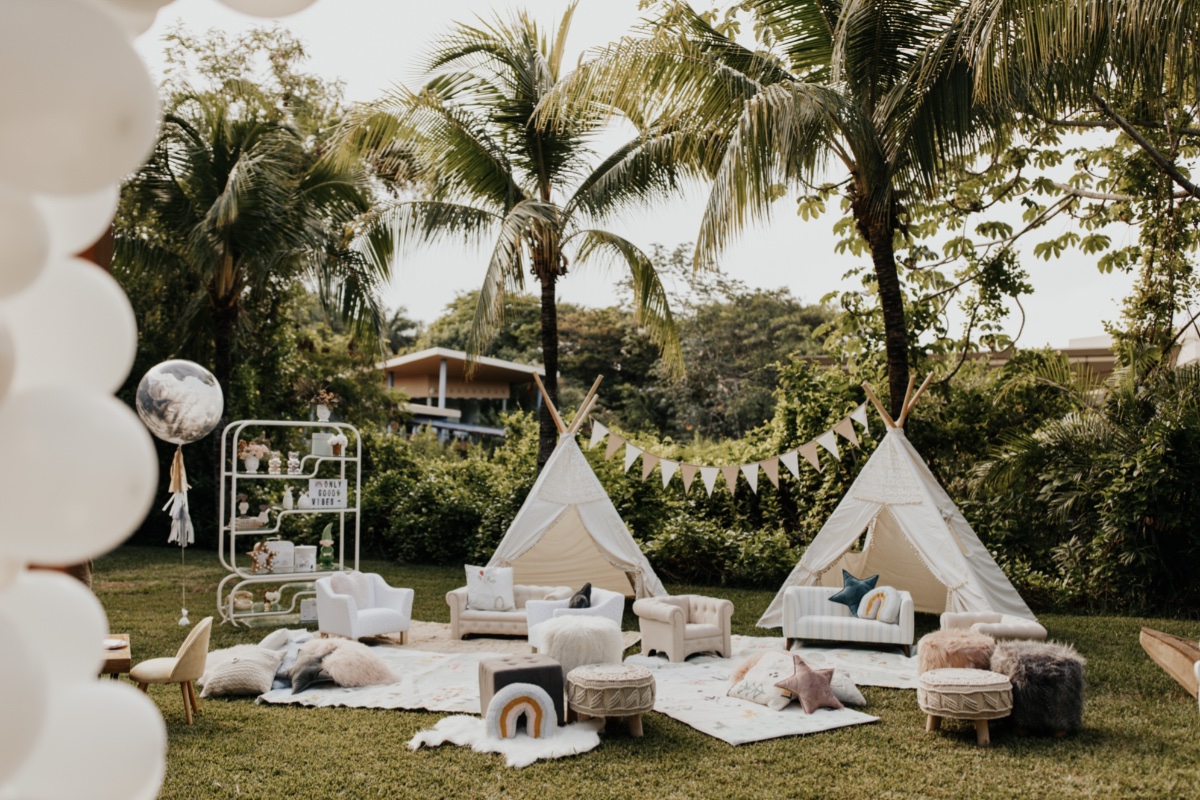 Bohemian kids party with teepees, lounge seating, and balloons