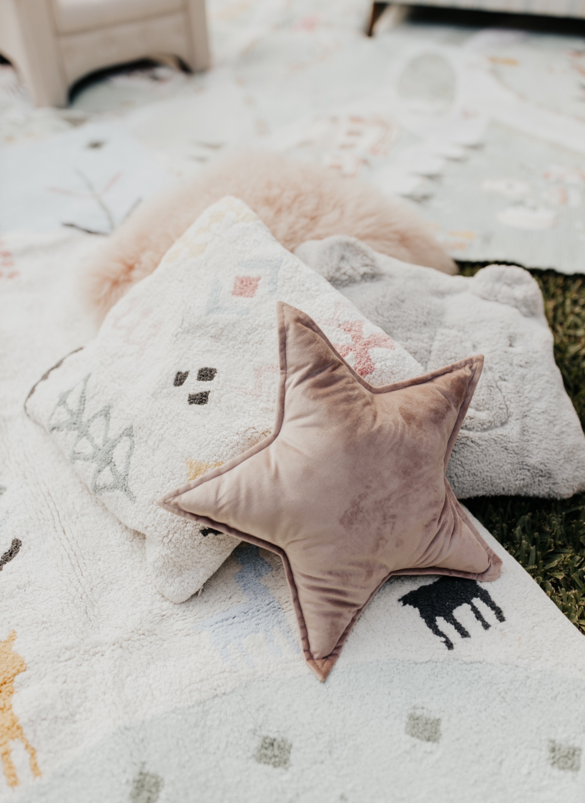 Pink star pillow on patterned rug