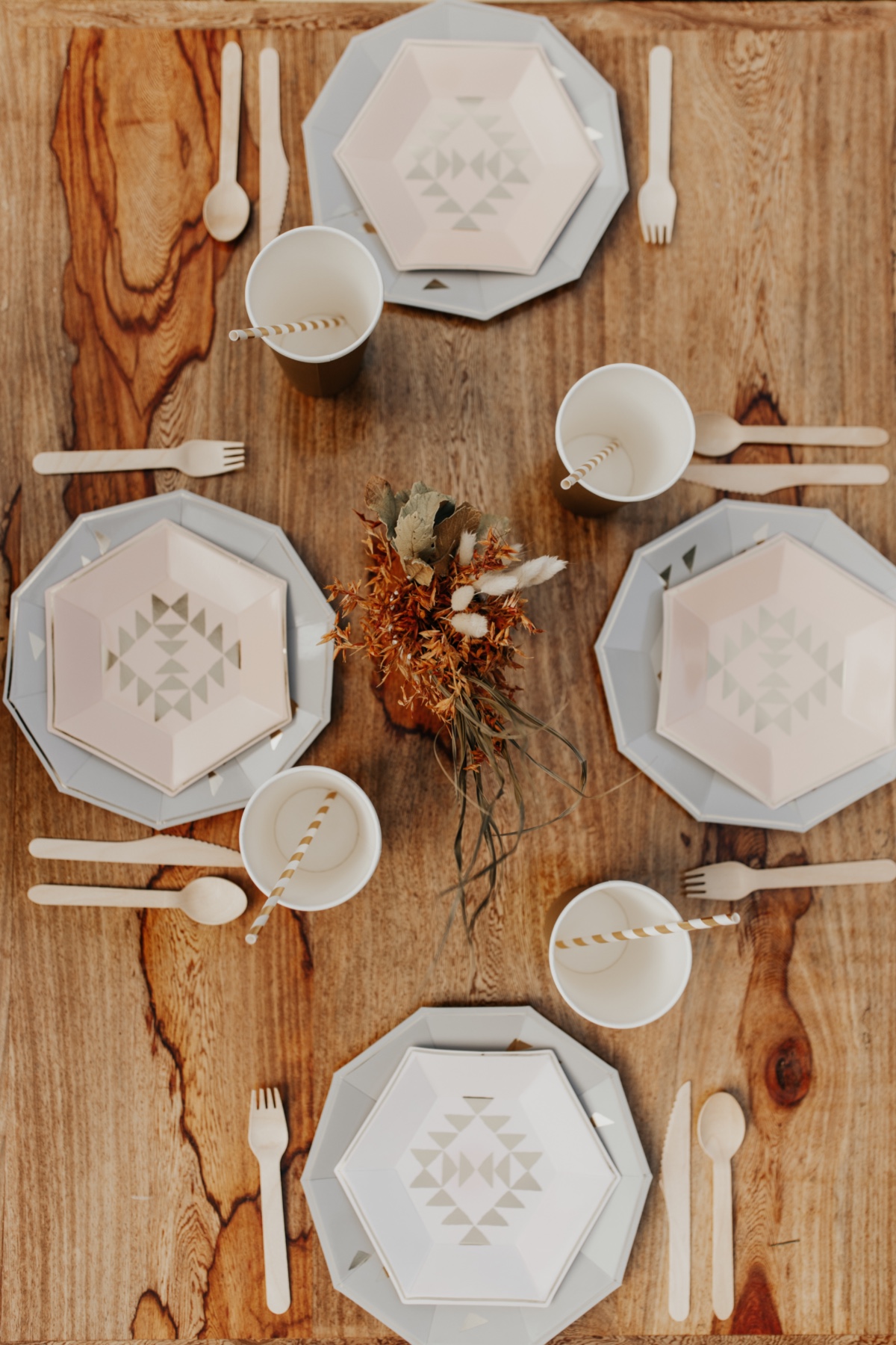 Table setting with modern patterned plates and wooden cutlery