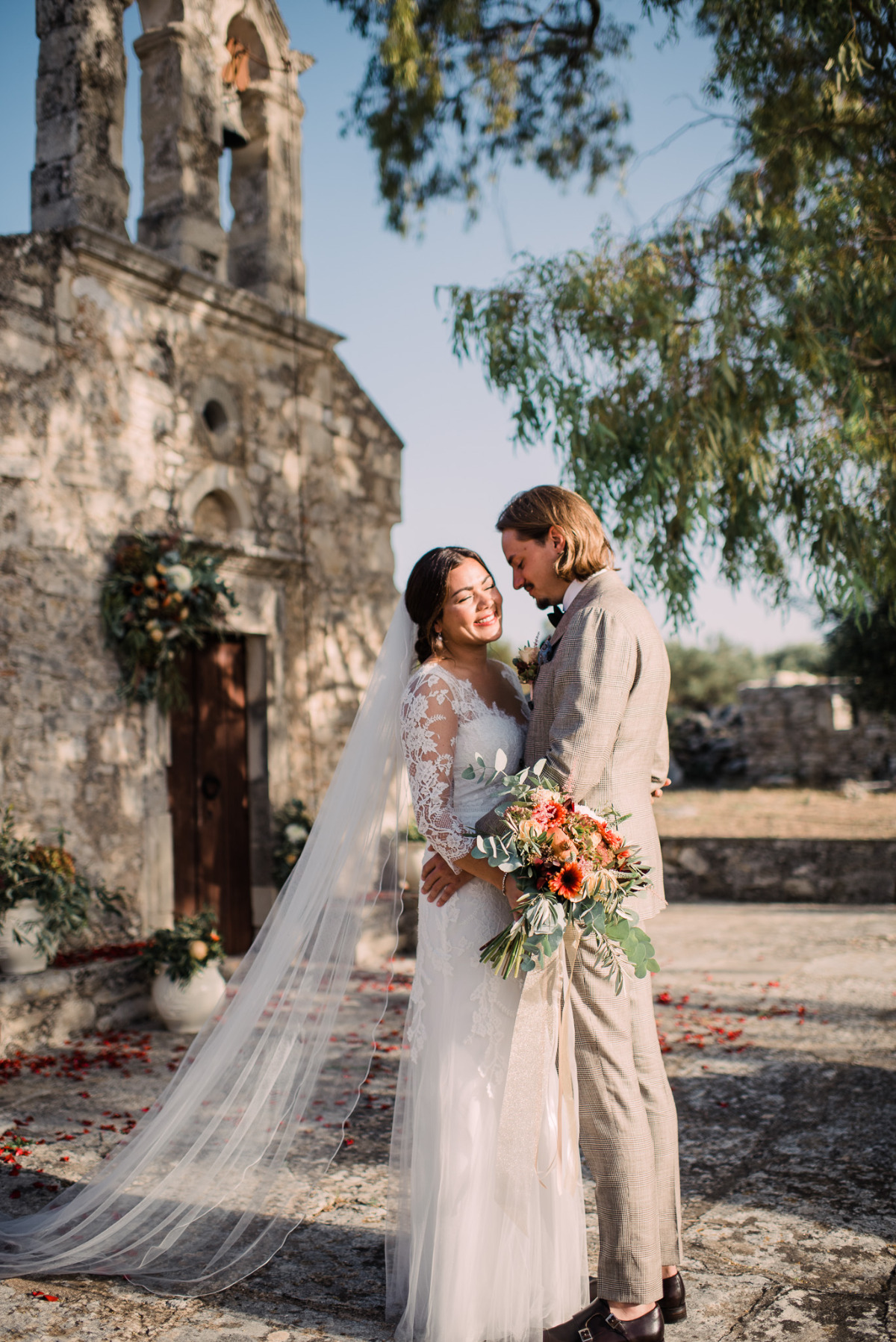 Bride and groom smiling at their rustic wedding venue