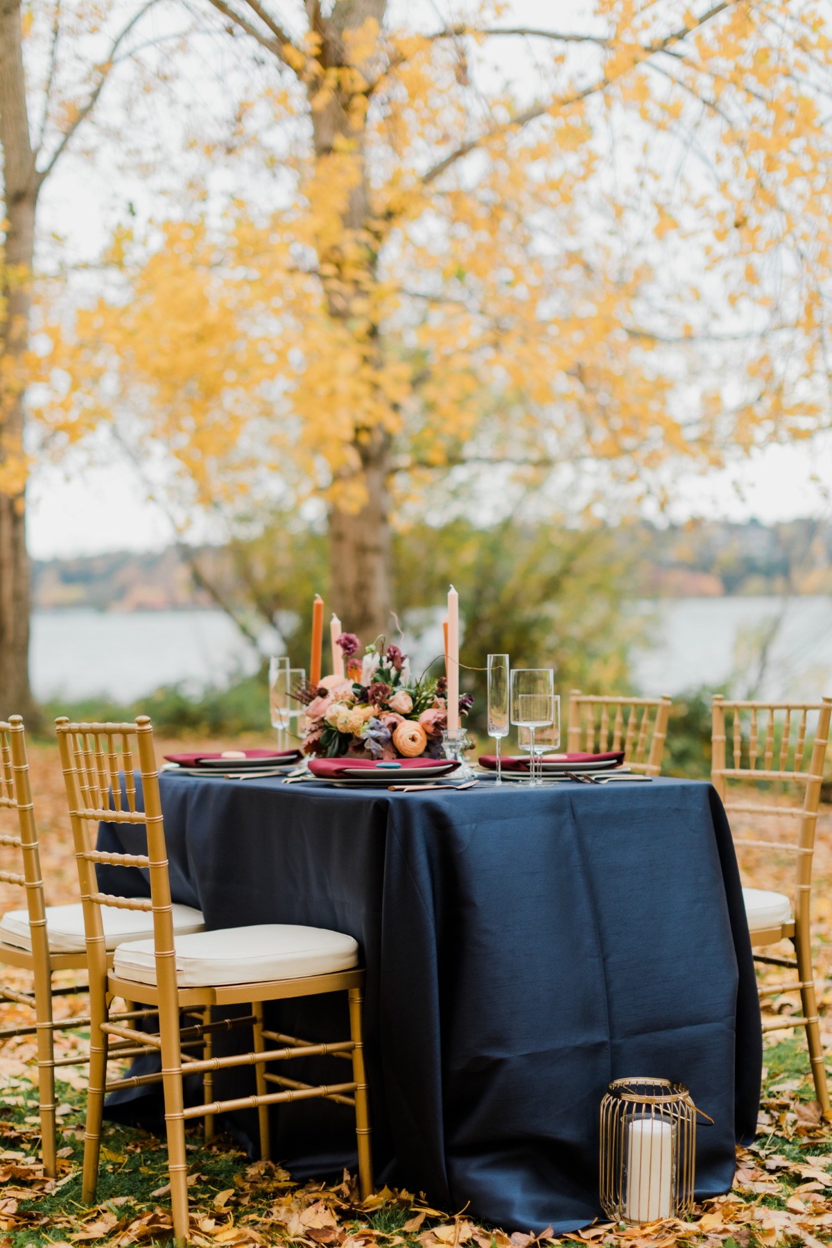 Elegant outdoor table setting with fall colors and decorations