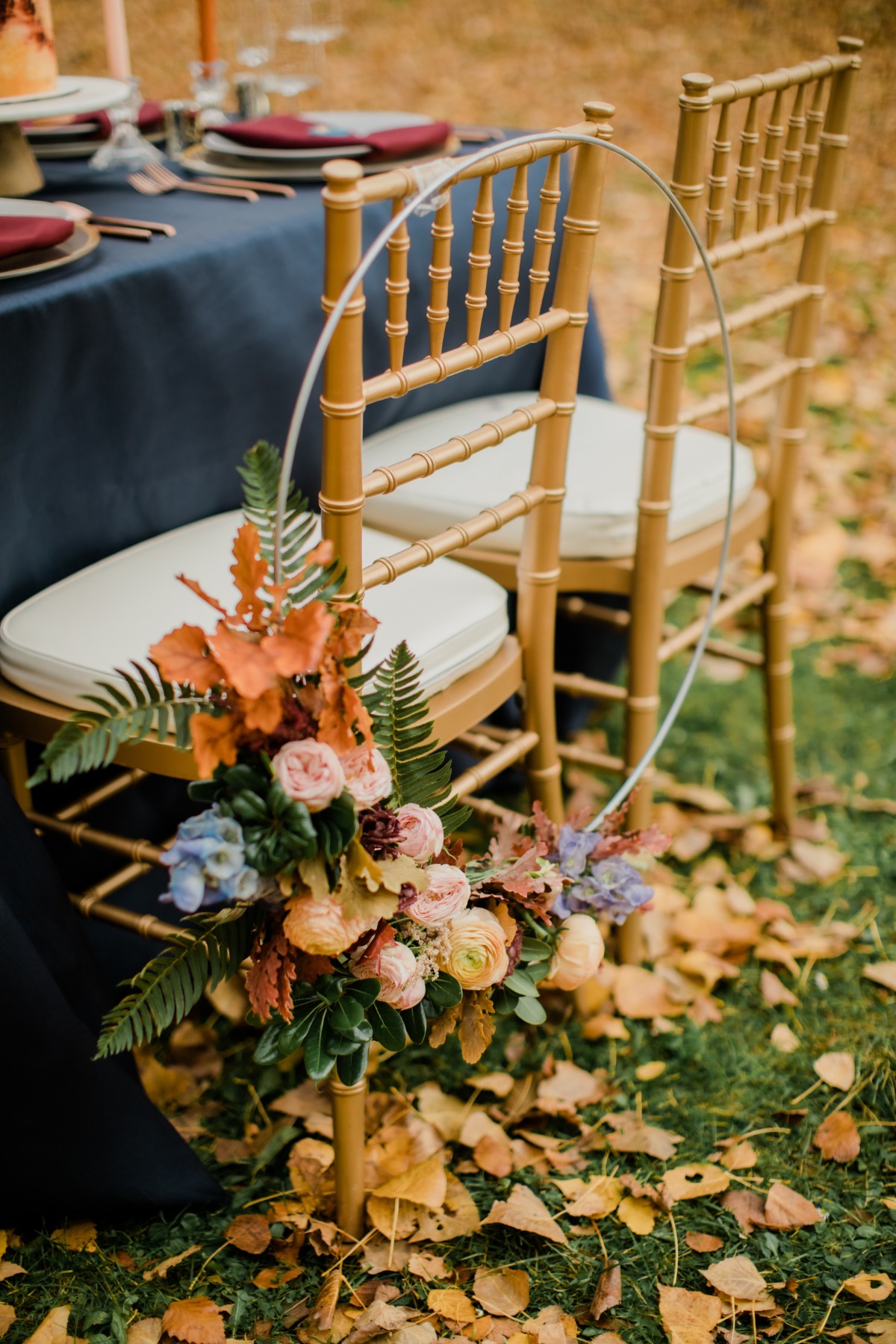 Elegant gold chairs with floral decoration for outdoor wedding