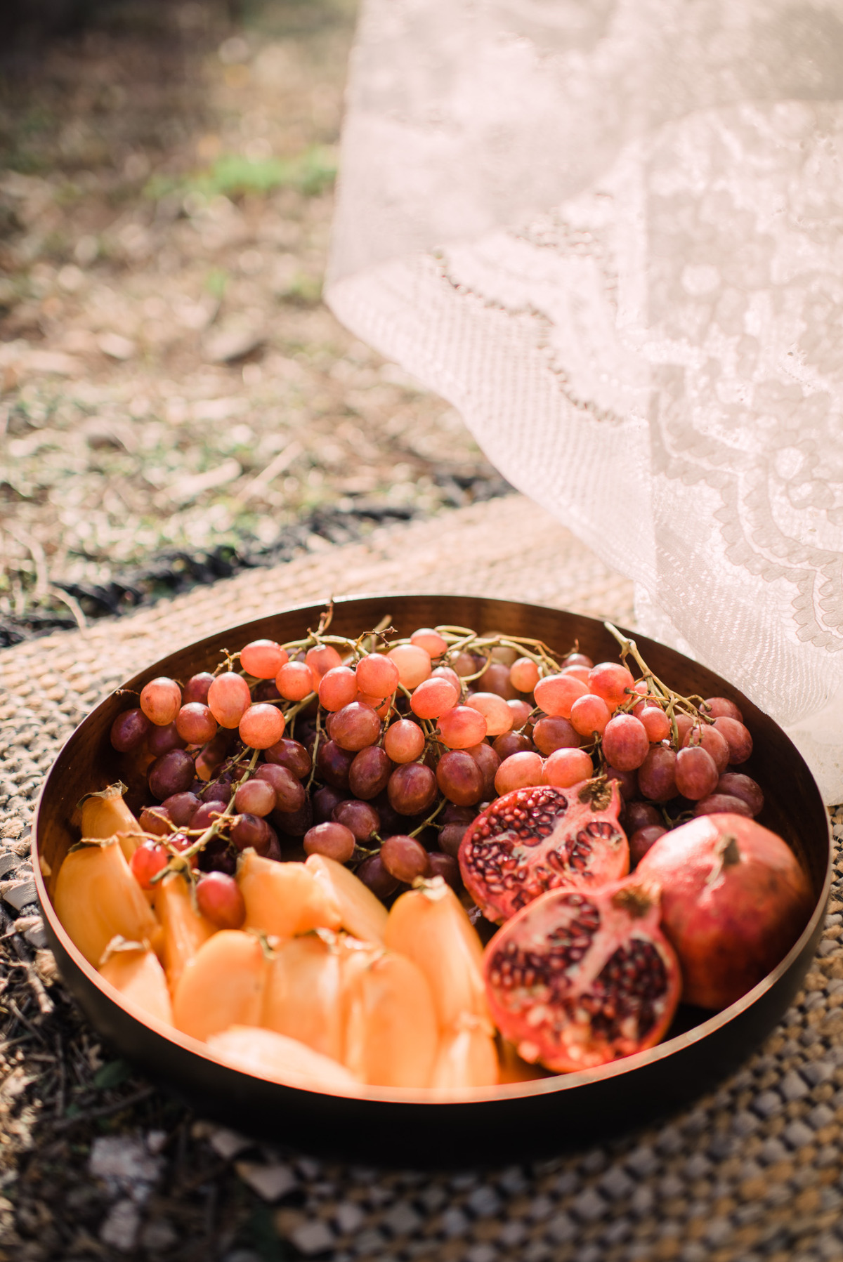 Bowl of grapes, persimmons, and pomegranates