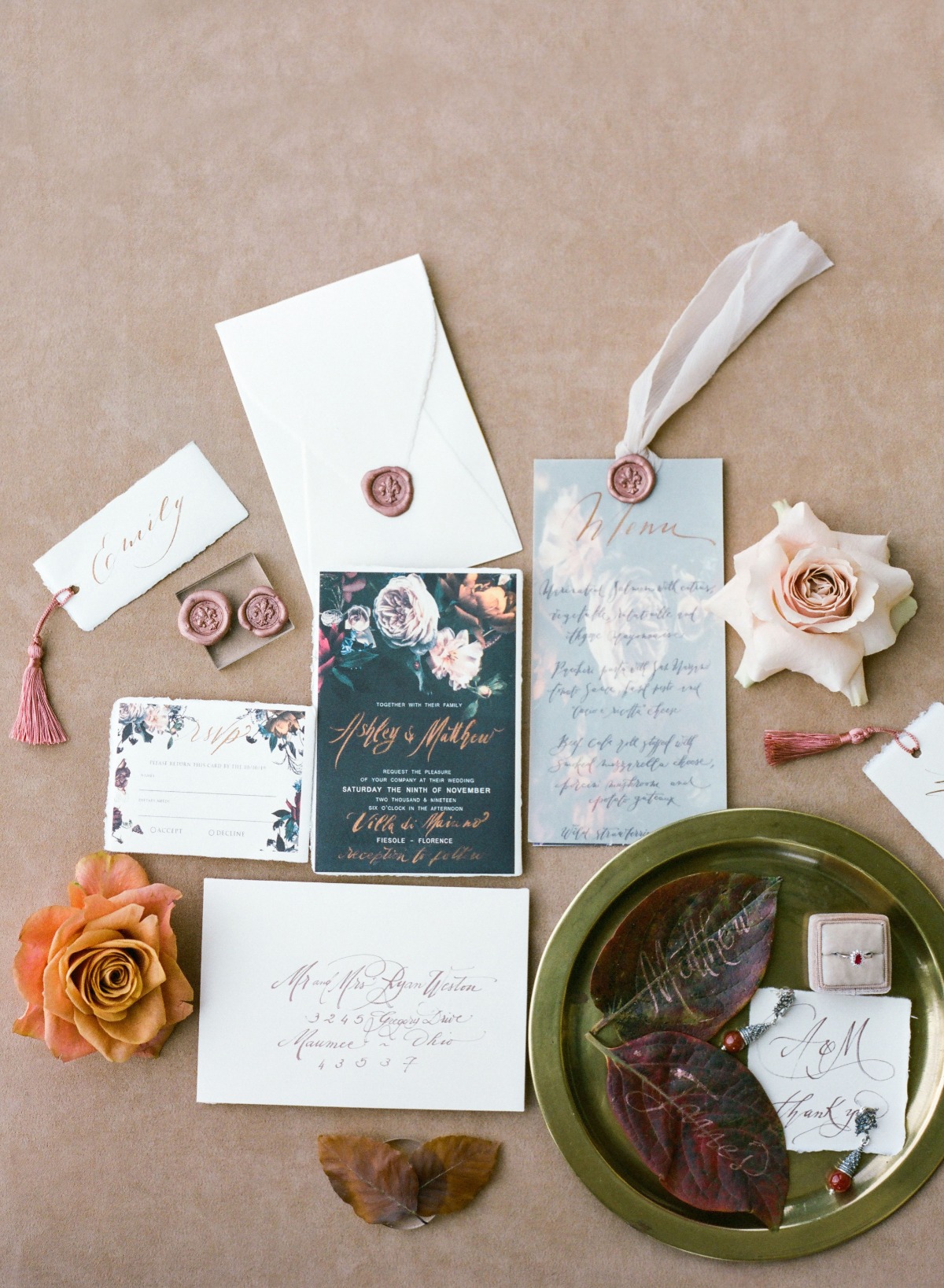 Elegant wedding stationery flat lay with floral accents and details