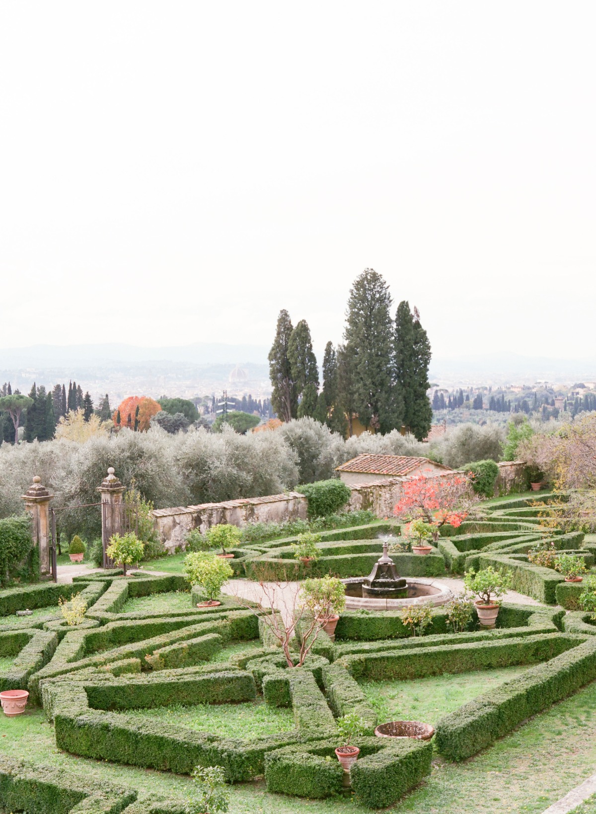 Formal garden with geometric hedges and water fountain overview