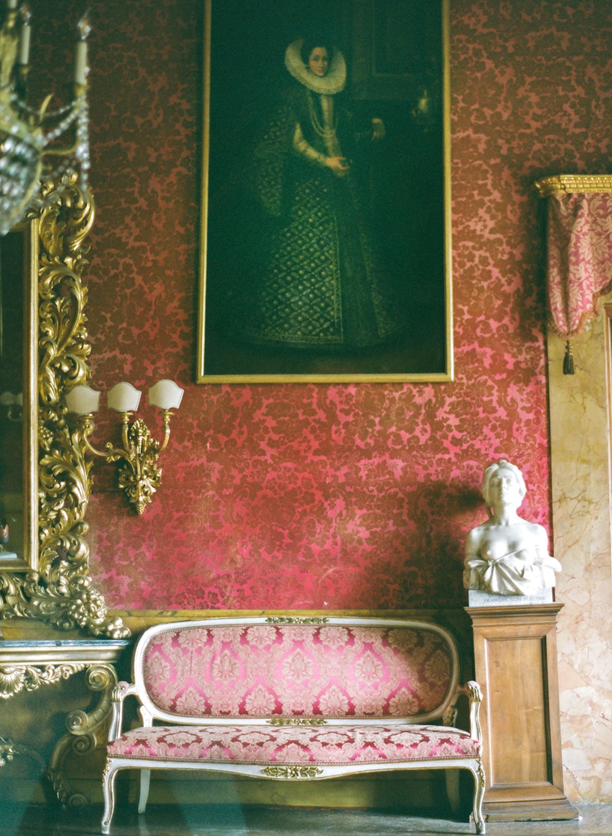 Elegant antique room with sofa, painting, and marble bust