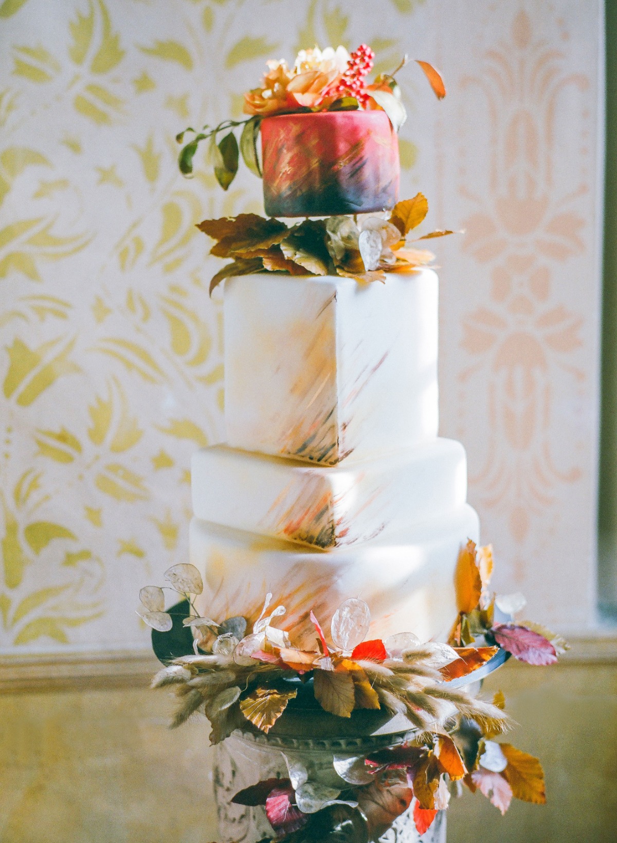 Elegant wedding cake with autumn flowers and leaves decorations