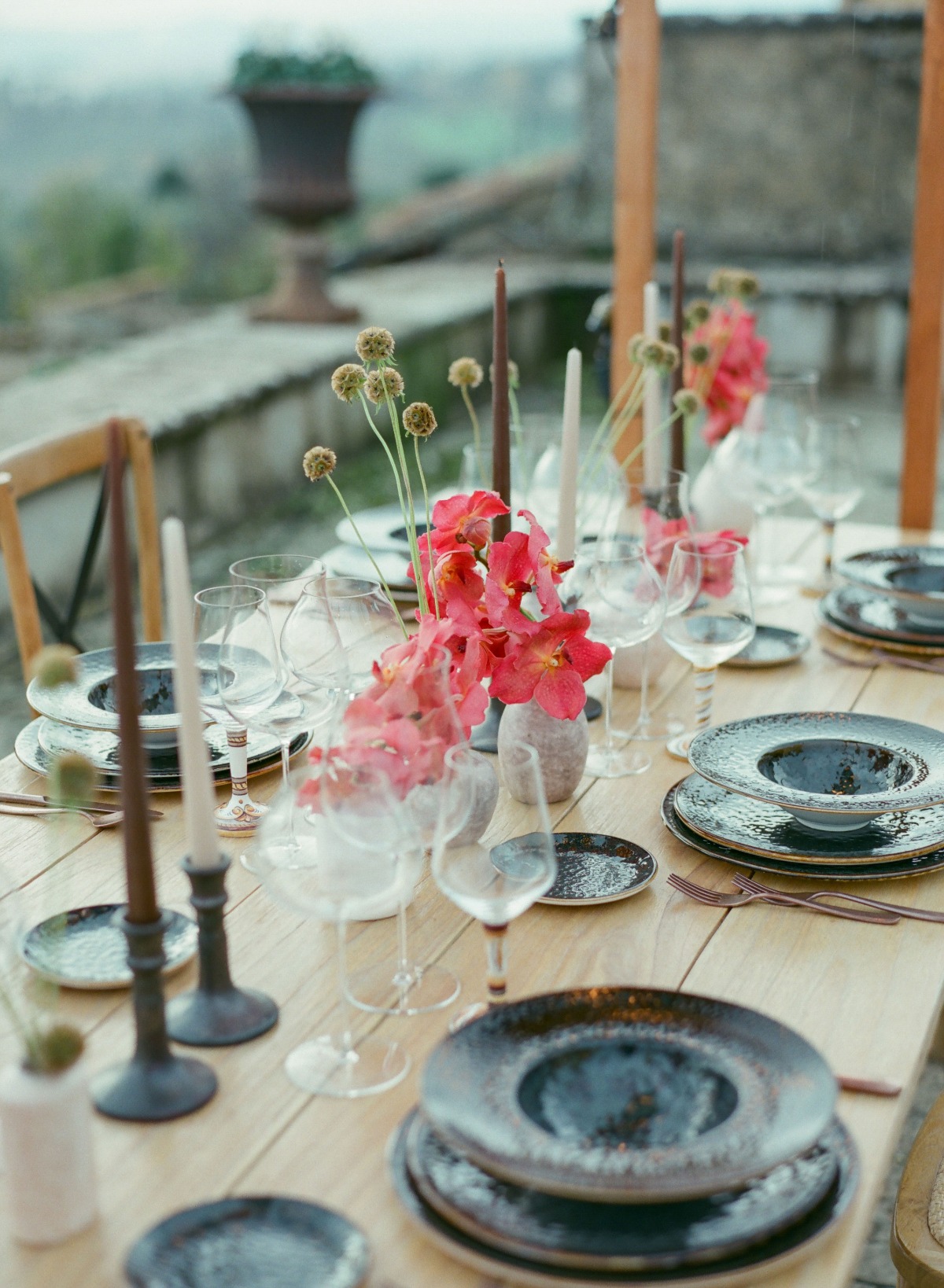 Elegant outdoor table setting with floral centerpiece