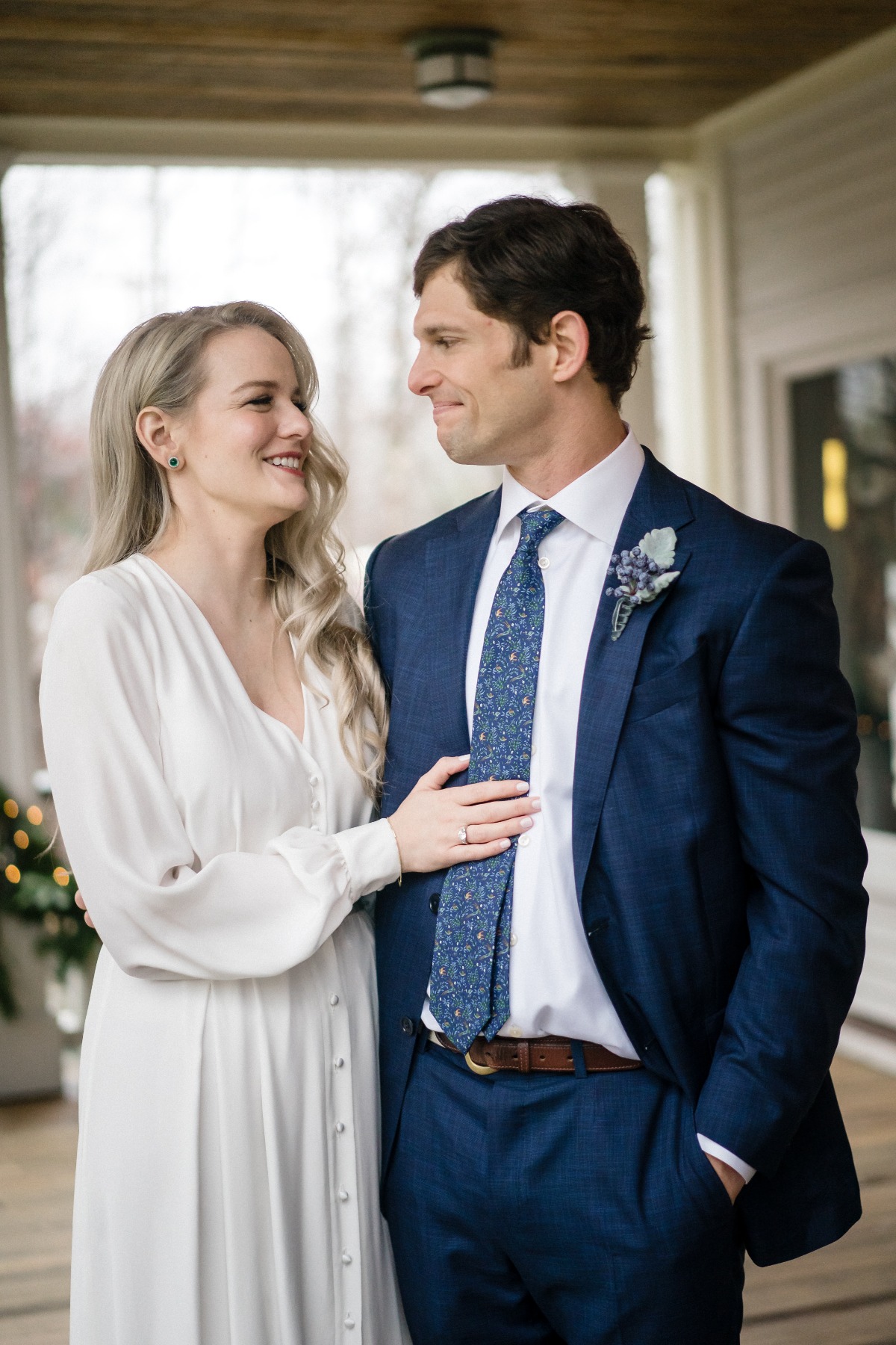 Happy couple smiling at each other on their wedding day in a house