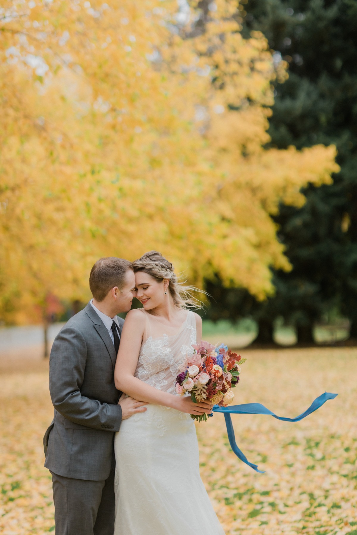Newlyweds share a tender moment in a beautiful autumn wedding photo