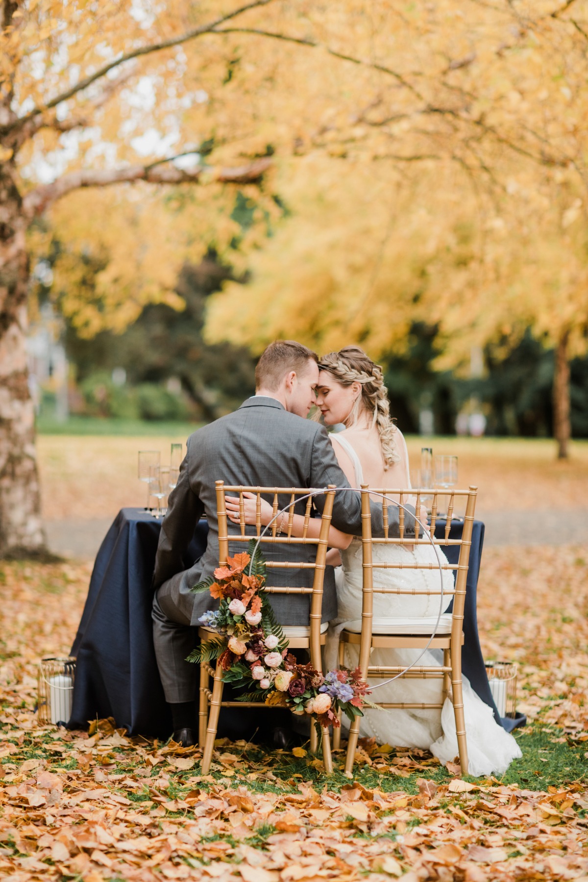 Bride and groom at autumn wedding table setting outdoors