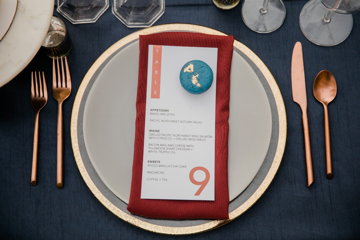 Elegant table setting with menu and copper cutlery details