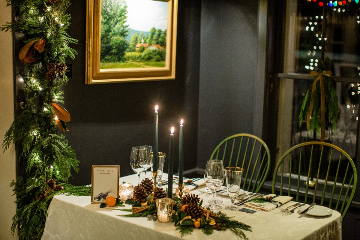 Cozy holiday dinner table with candles and festive decorations