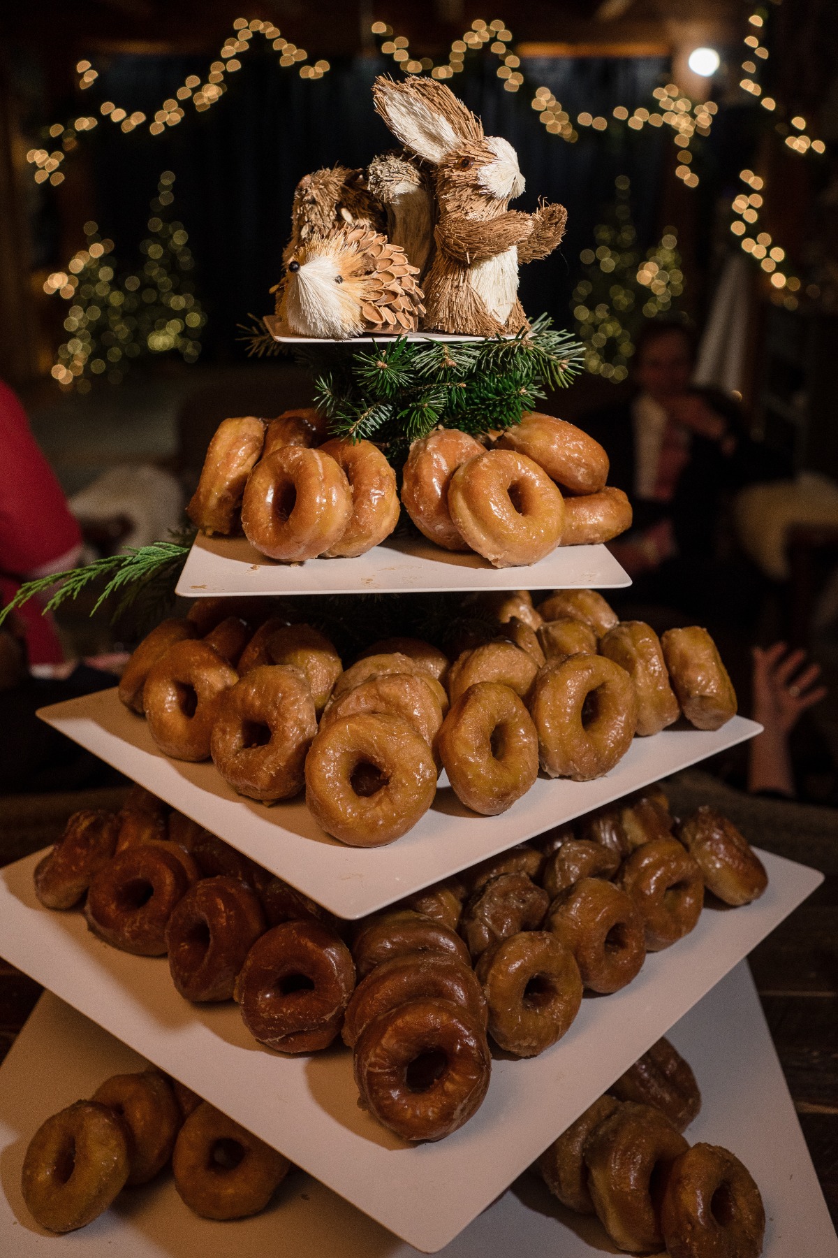 Delicious donut tower with festive holiday decorations and lights