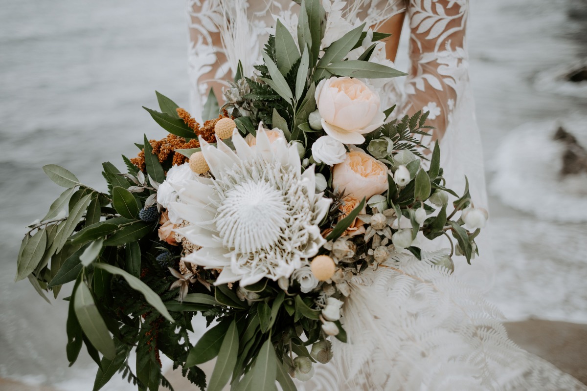 Stunning beach wedding bouquet with protea and roses