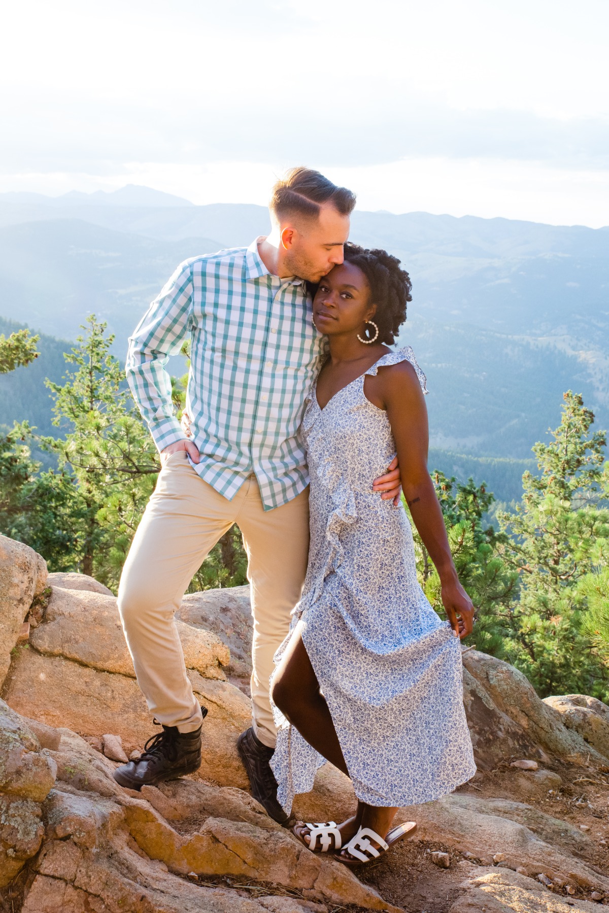 Couple embracing on mountaintop, romantic view