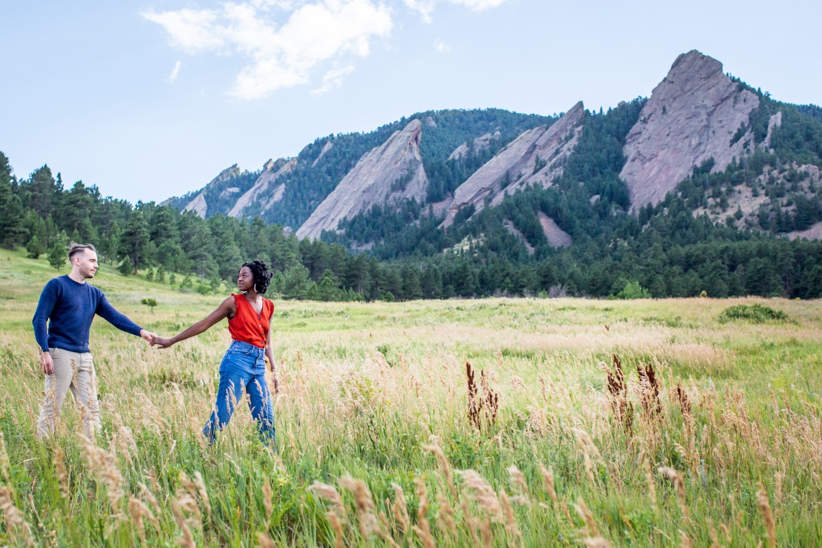 Couple holding hands in mountain meadow