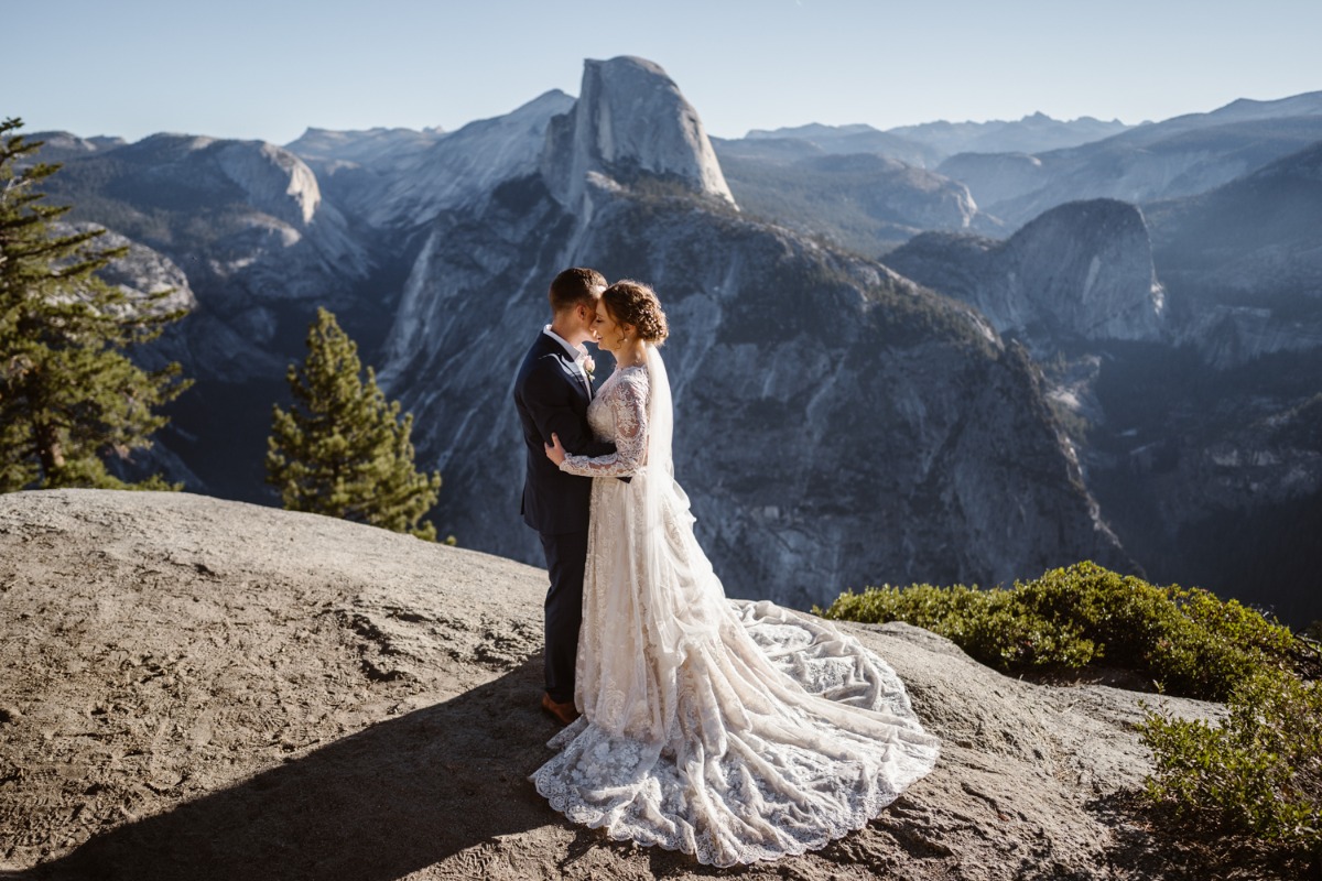 Wedding couple embraces with scenic Half Dome view