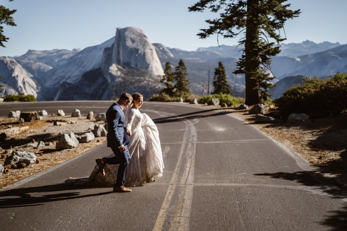 Yosemite elopement couple walks road near Half Dome view