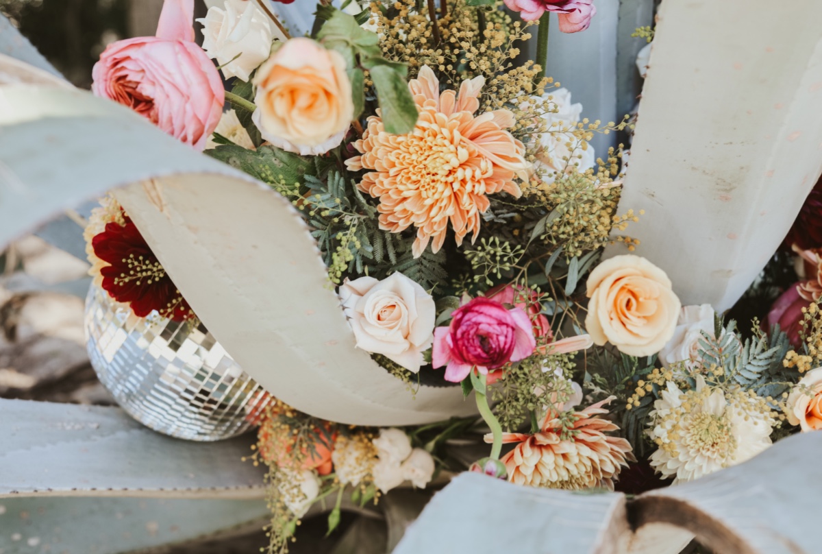 How To Incorporate Bold Florals + A Disco Ball Into Your Boho Beach Wedding