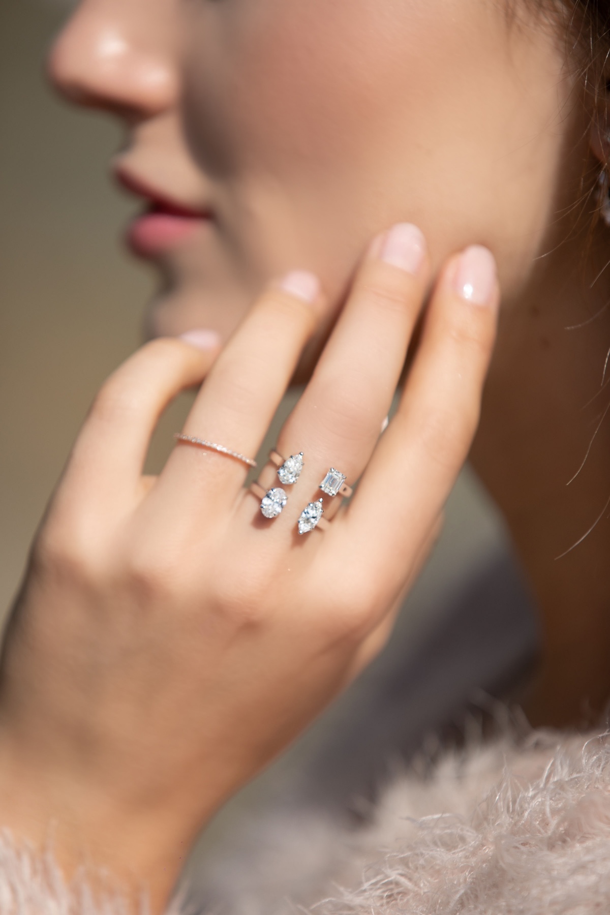 Elegant woman wearing modern diamond rings on hand