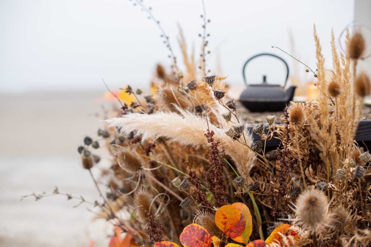 Dried floral arrangement with teapot; autumnal scene