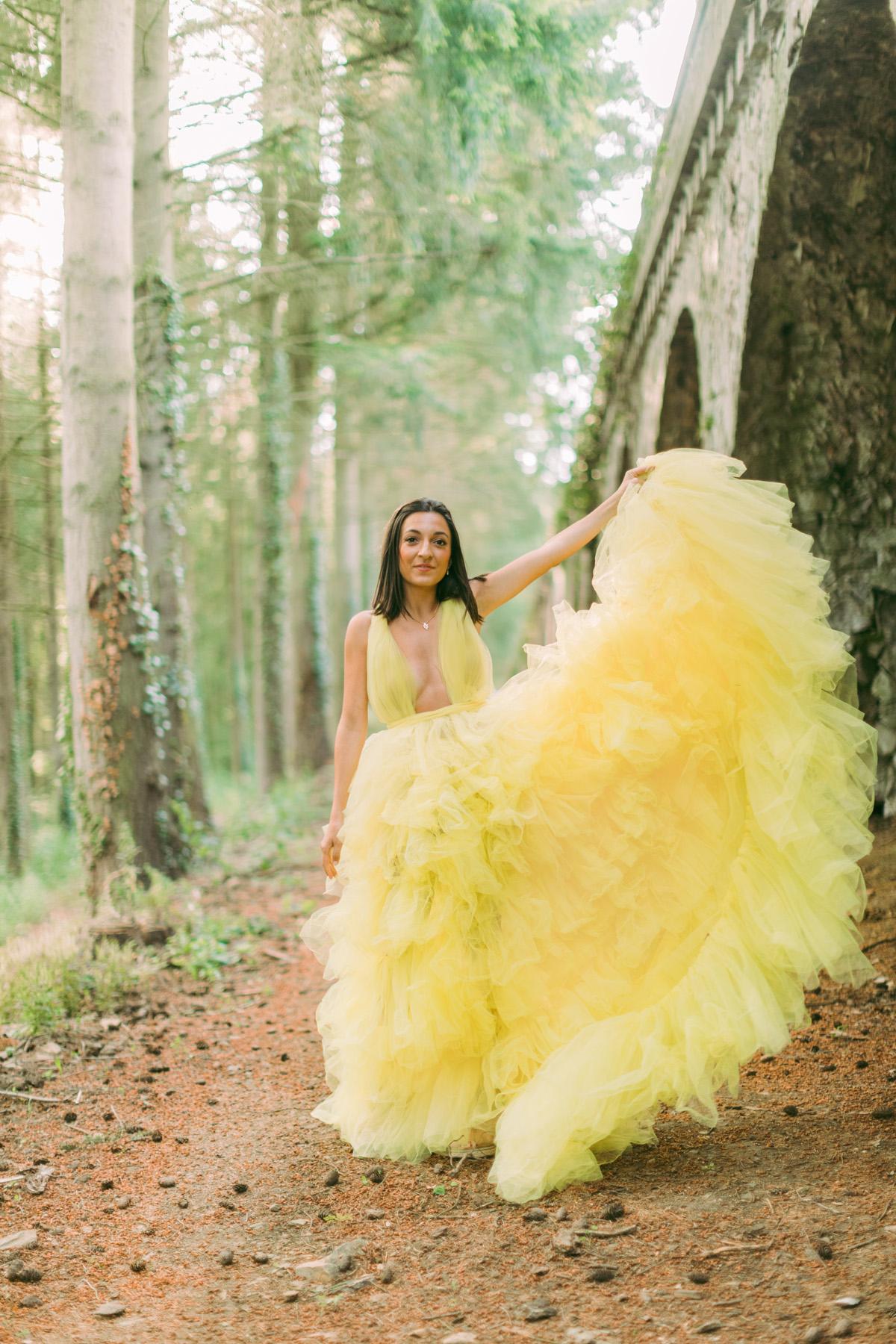 Woman in yellow dress in forest photoshoot