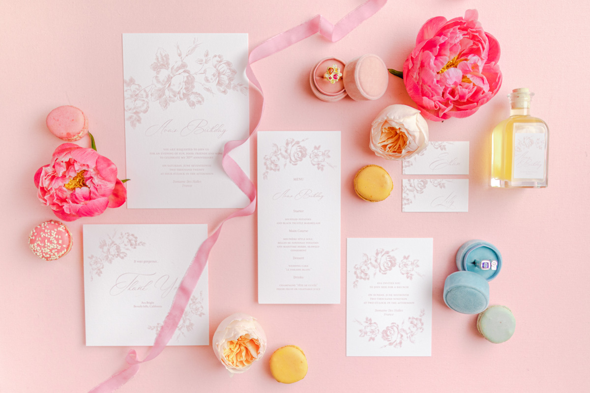 Elegant wedding stationery with flowers and macarons