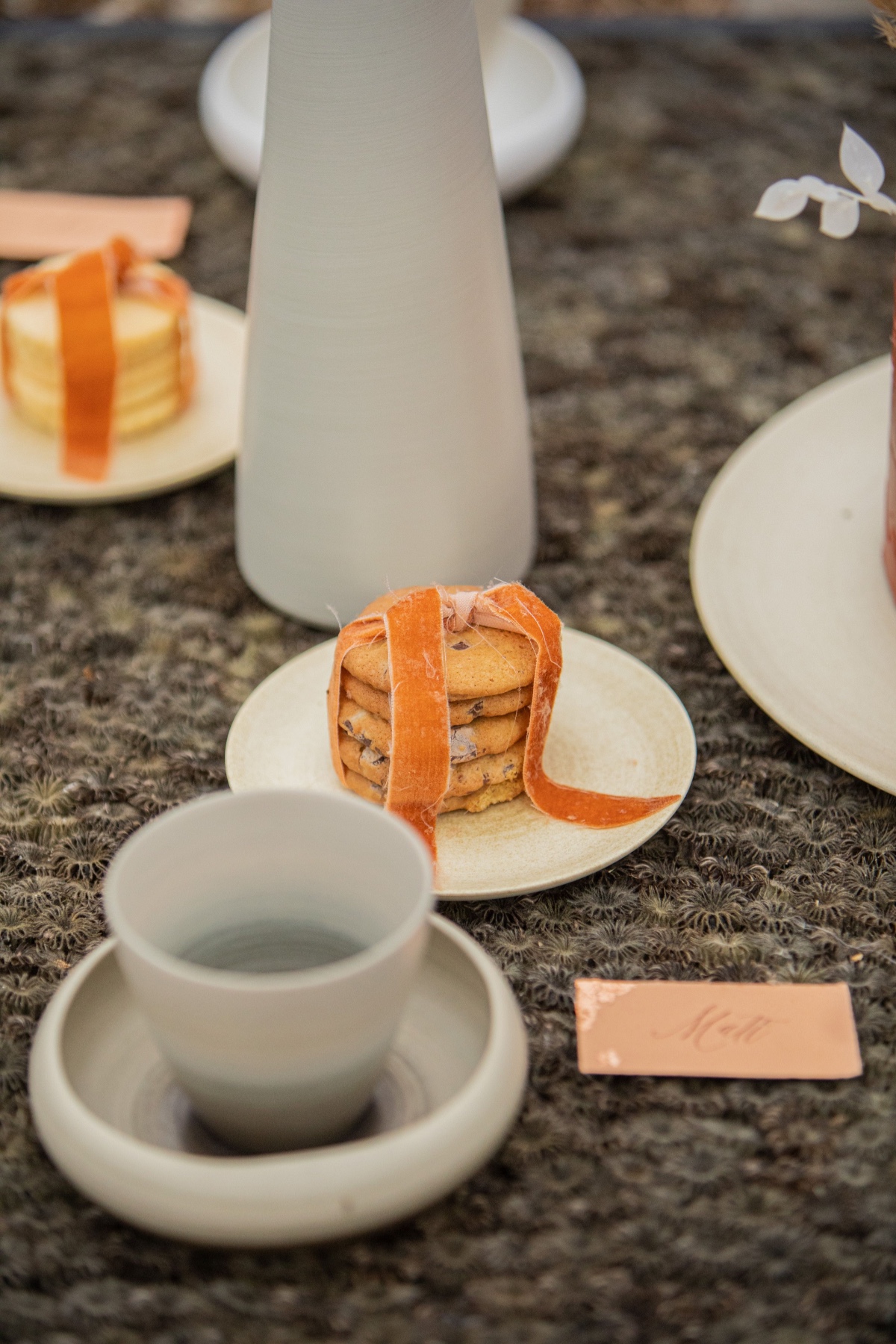 Cookies with ribbons and a cup on a decorative table