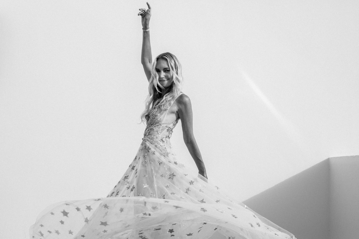 Woman in starry dress dancing black and white image
