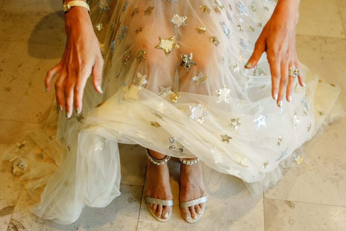 Woman in star spangled tulle gown with silver sandals