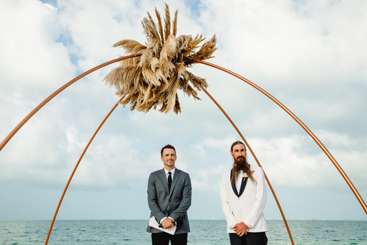 Two stylish grooms at their beautiful beach wedding
