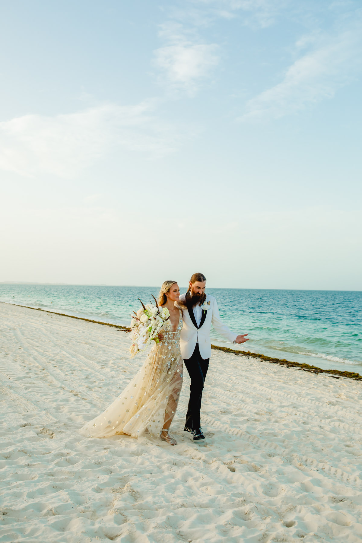 Romantic wedding couple walking on a beautiful beach